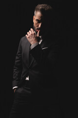 Seductive man touching his lip with finger