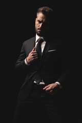 Serious man in suit holding his jacket