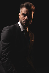 Serious mysterious man posing in the dark