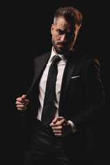 Confident man opening his suit jacket