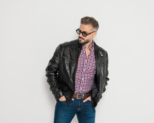 Fashion man looking to side with hands in pockets