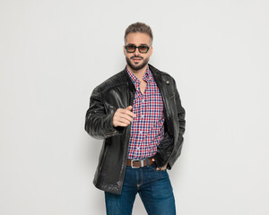 Confident casual man pointing finger at camera