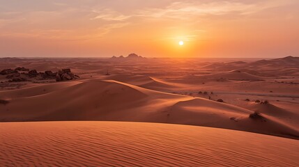 Dramatic desert sunset paints vast sand dunes in warm light