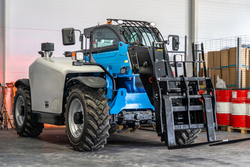 Modern telescopic handler in industrial warehouse, heavy lifting and material handling equipment for logistics, construction and warehouse operations.