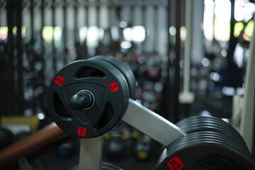 A close-up of weight plates in a gym, showing fitness equipment and workout equipment