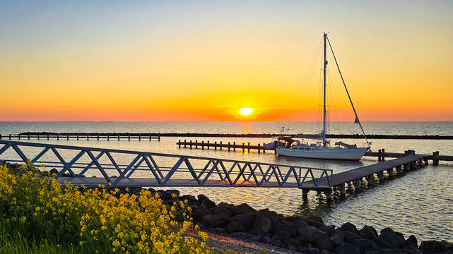 Sunset Reflections at the Marina with Sailboats and Pier