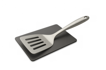 Metal kitchen spatula turner with slotted head and stainless steel handle for cooking on black silicone mat, transparent background