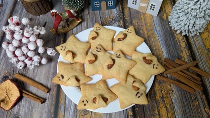 Homemade Christmas cookies on plate with holiday decorations. 