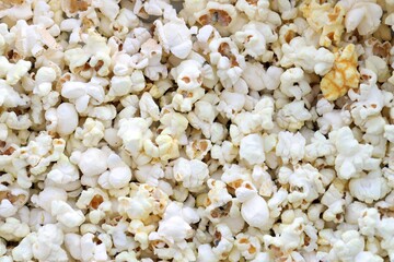 Flatlay of salted popcorn with cheese. Heap of homemade delicious popcorn on a rustic wooden table