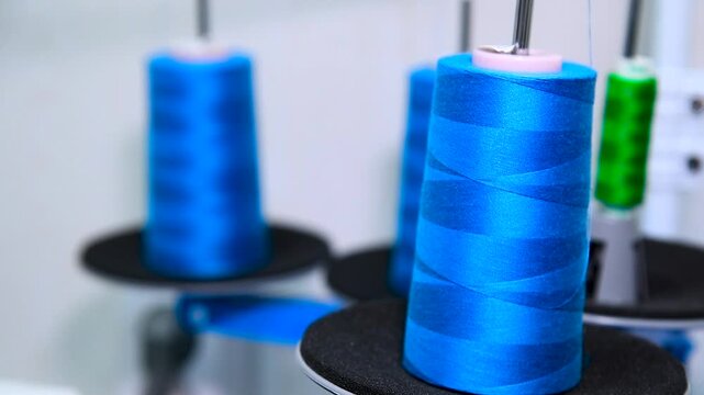 Thread spools for weaving in automatic sewing machines in tailor colorful industrial clothing material