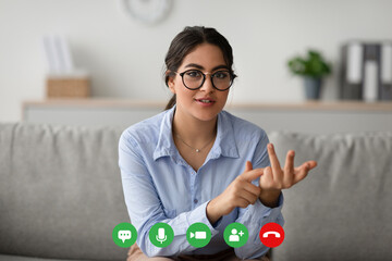 Professional psychologist conducts a virtual session with a client from her office. She engages positively, offering support and guidance during the online consultation.