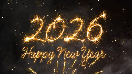 2026 Happy New Year with the number above the text, all formed by brilliant gold light on a deep black background with festive firework bursts and shining dust