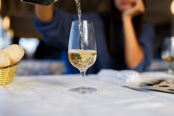 Person pouring manzanilla sherry into a wine glass