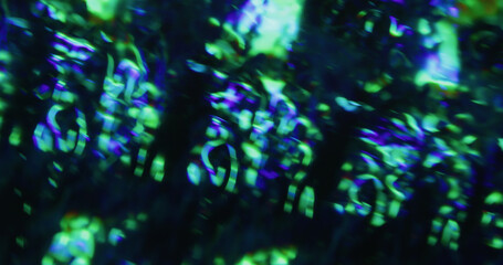 Glow flare defocused. Flash leak. Green blue color uneven glossy texture. Abstract twinkle kaleidoscope effect on black background.