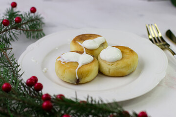 Apetite cheesecakes on a white plate. Christmas Breakfast