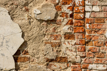 Brick old, destroyed red wall, background with texture of old red brick wall and plaster elements