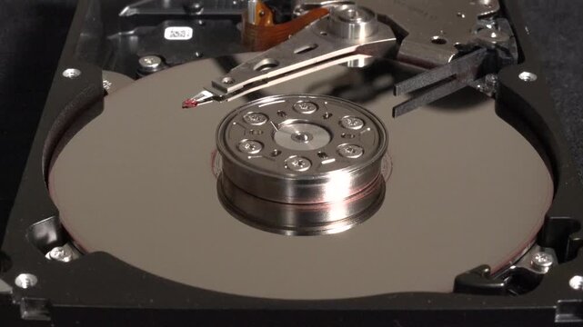Spinning hard disk, with flashes of light and surface UN-cleaning 