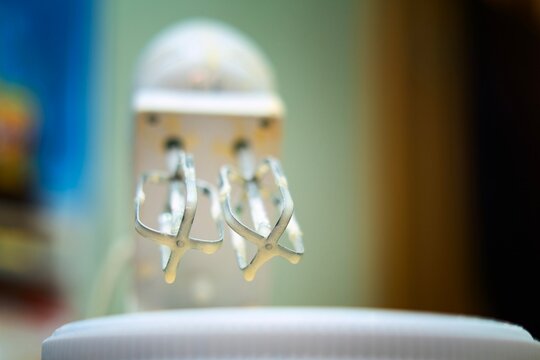 Whisk attachment raised after mixing, with fresh dough traces - Powered by Adobe