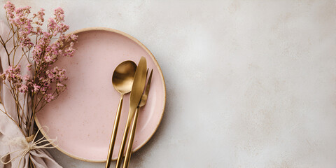 Flat lay banner with elegant table setting of pink ceramic plate and golden cutlery on soft Linen