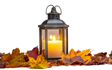 Decorative fall arrangement featuring a glowing candle inside a rustic lantern with surrounding foliage isolated on transparent background PNG