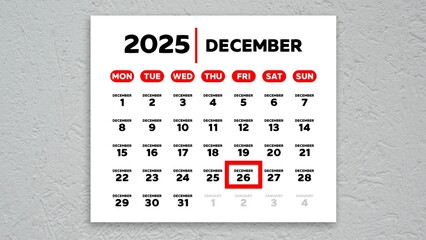 The date December 26th marked with a red cursor on the wall calendar 2025