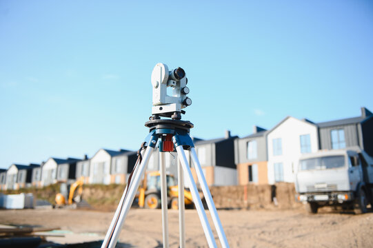 Theodolite measuring land on new housing construction site