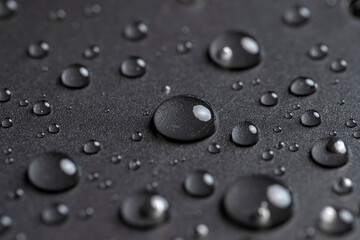 plastic covered with water , details of the wet part of an object made of black plastic