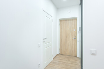 Modern Home Apartment Entryway with Wooden and White Interior Doors