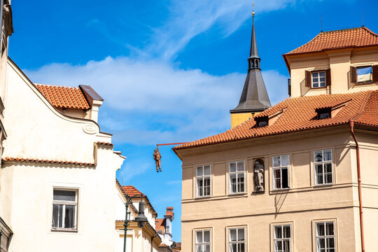 Prague, Czech Republic, August 9, 2023. The Hanging Man is a statue by sculptor David Čern&yacute;. It depicts Sigmund Freud hanging from a beam above Husova Street in the Old Town district.