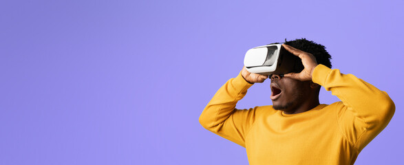 A person wearing a virtual reality headset shows enthusiasm while experiencing an immersive environment. The background is a vibrant shade of purple, highlighting the moment of engagement.