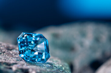 A blue gemstone sits on a rock