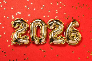 New year 2026 balloon celebration card. Gold foil helium balloon number 2026, party decoration, gold confetti stars on red background. Flat lay, merry christmas banner, happy holidays concept.