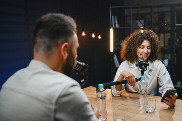 Podcasters recording audio content in modern studio