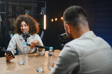 Two content creators recording podcast in modern studio