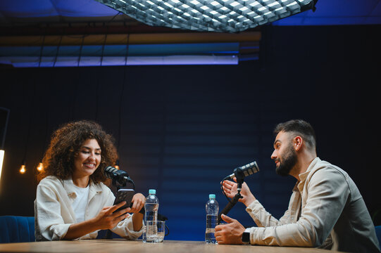 Two content creators recording podcast in modern studio - Powered by Adobe