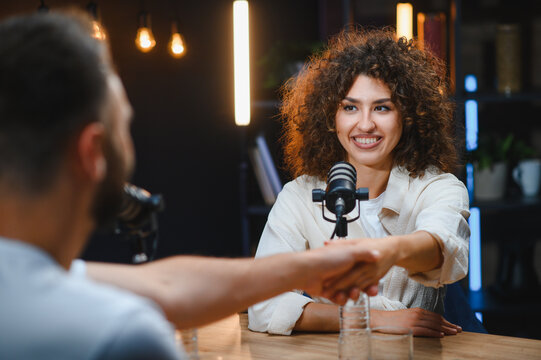 Podcasters shaking hands during recording session