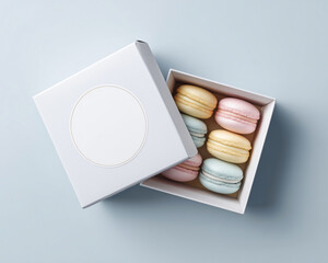 Top view of a box with blank label filled with colorful pastel macarons