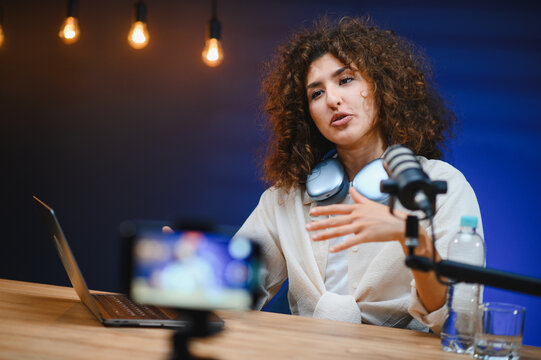 Content creator recording video blog with professional microphone and headphones