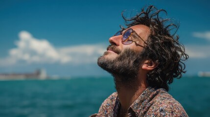 Serene Man Relaxing Outdoors by Ocean on Sunny Day