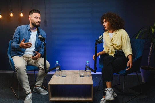 Content creators recording podcast in professional studio - Powered by Adobe