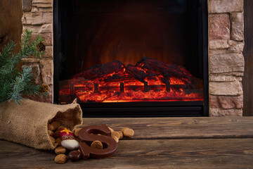 Obraz premium Saint Nicholas - Sinterklaas sweets near the fireplace