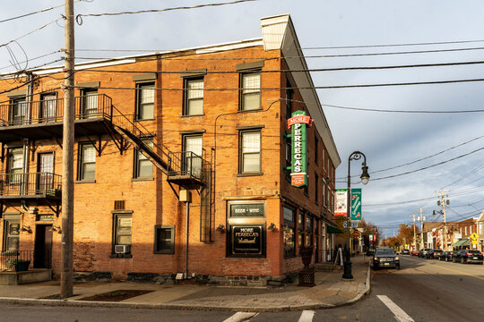 Schenectady, NY - US - Nov 15, 2025 A historic brick building on a street corner houses More Perreca's Italian Kitchen, offering beer and wine in a charming small-town setting.