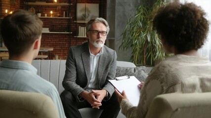 Therapist meeting with a patient and a family member in a counseling session