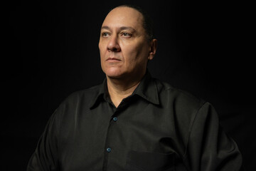 Portrait of a young Brazilian gentleman, portrait of a middle-aged man from Brazil, black background, selective focus.