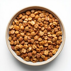 Overhead view of a rustic ceramic bowl filled with a generous portion of roasted hazelnuts on a clean white background