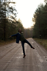 Man Dancing and Having Fun on Dirt Road Through Forest