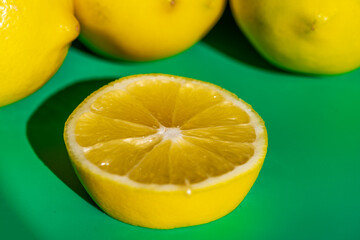 A vibrant yellow lemon resting on a table, captured in soft natural light. The image highlights the fruit&rsquo;s bright color, fresh texture, and simple composition, making it suitable for food photography