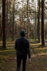 Man Walking Through the Forest on a Sunny Day