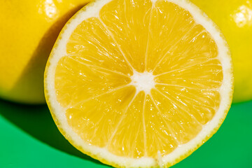 A vibrant yellow lemon resting on a table, captured in soft natural light. The image highlights the fruit&rsquo;s bright color, fresh texture, and simple composition, making it suitable for food photography