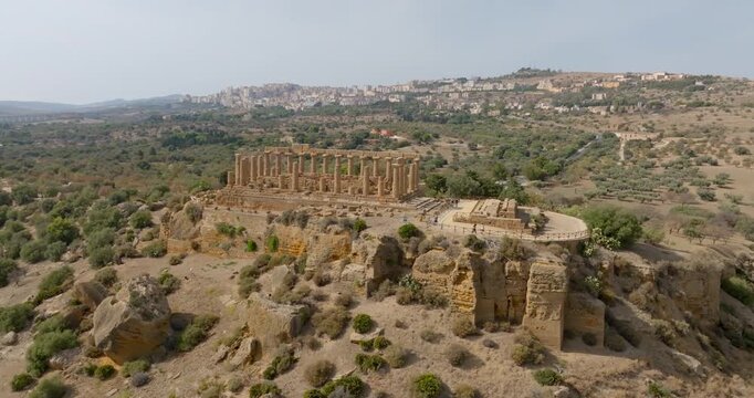 Aerial view of the Temple of Hera (or Roman Juno), Sicily, Italy. Known as Temple D, it's a Greek temple in the Valley of the Temples. In the background, on the hills, is the city of Agrigento.